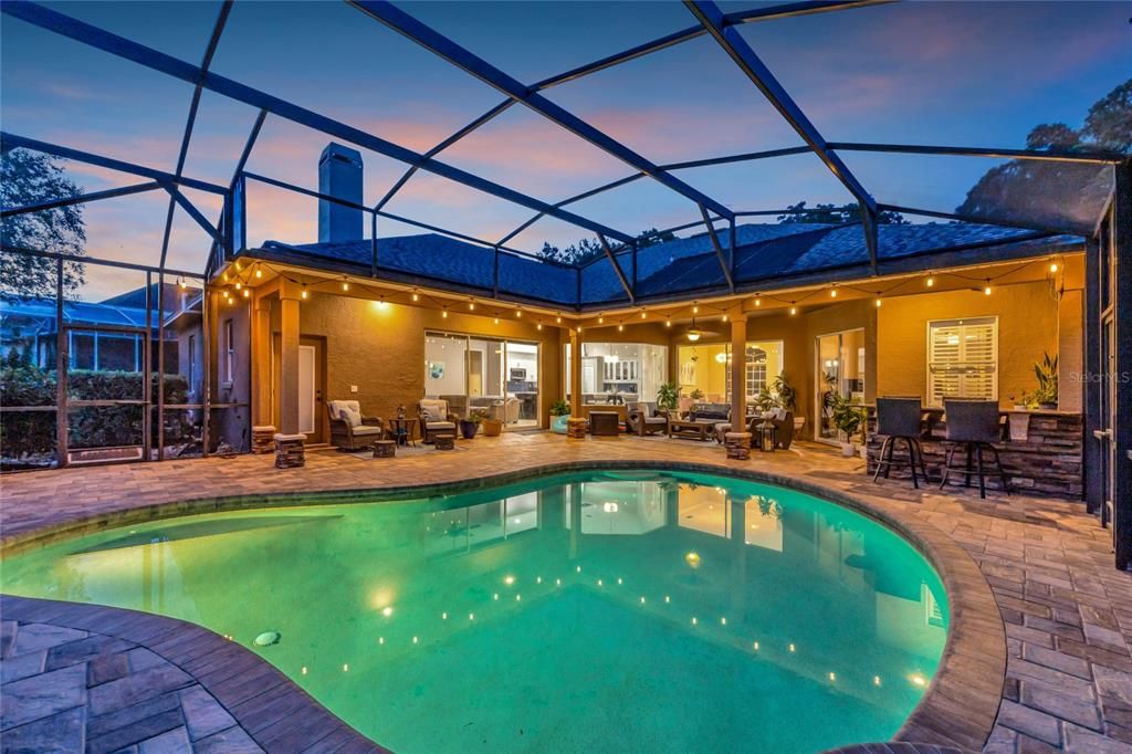 Twilight view of pool and lanai