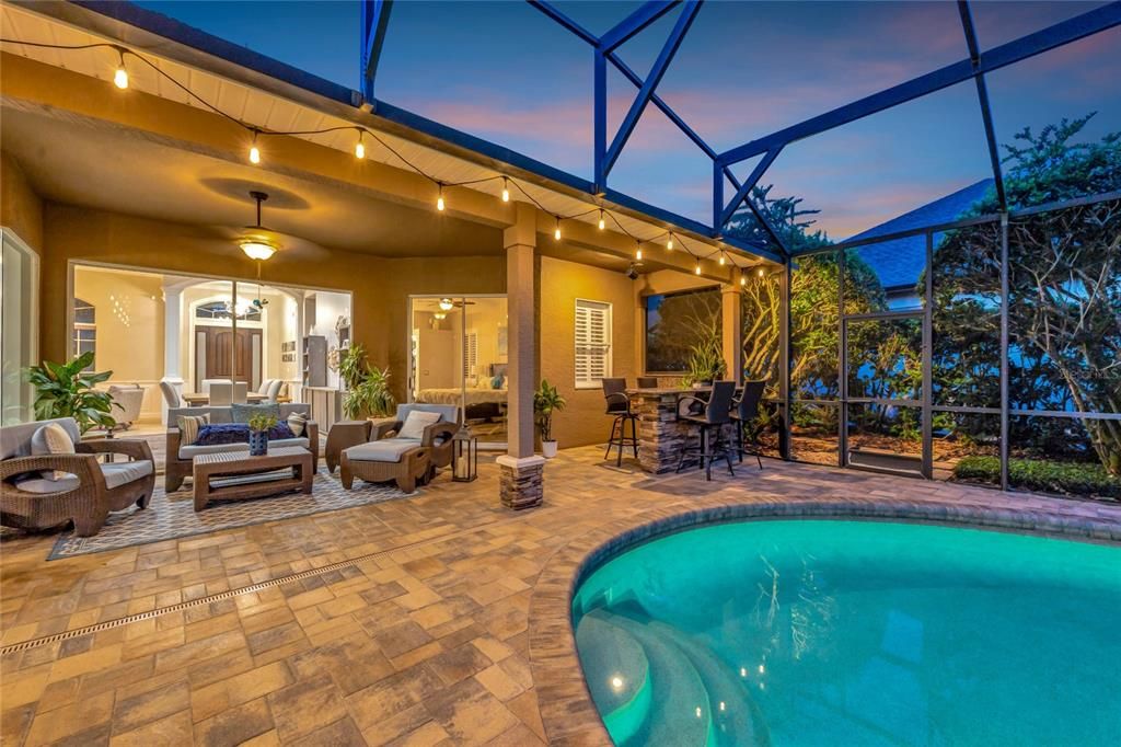 Twilight view of pool and covered lanai