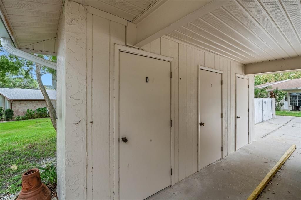 Exterior storage room located by carport~