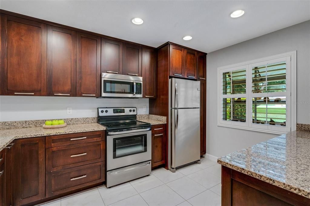 Newer stainless appliances, solid wood cabinets, granite countertops, and recessed lighting~