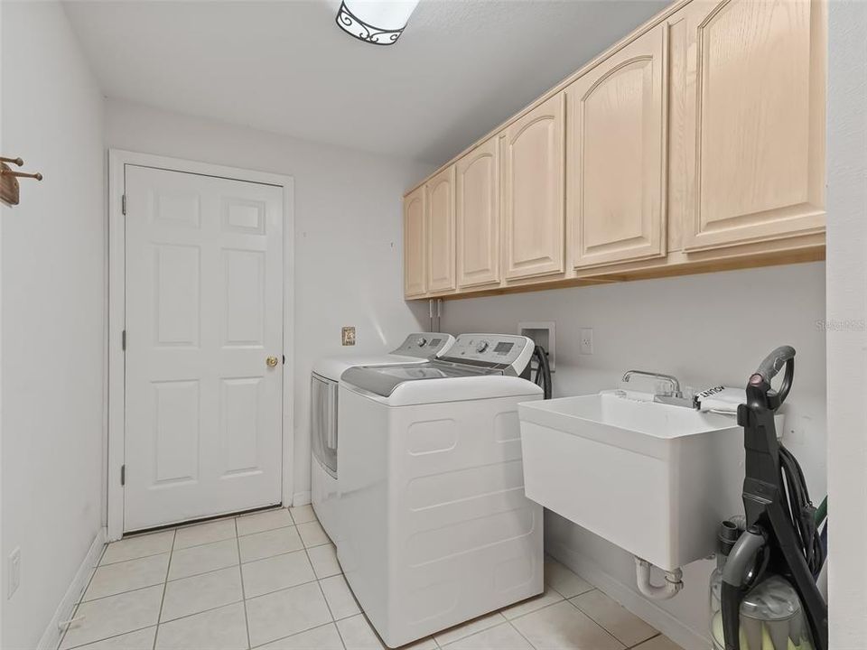 Laundry room near kitchen and garage.