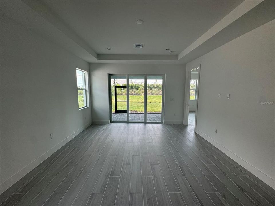 Great room and casual dining area with tray ceiling