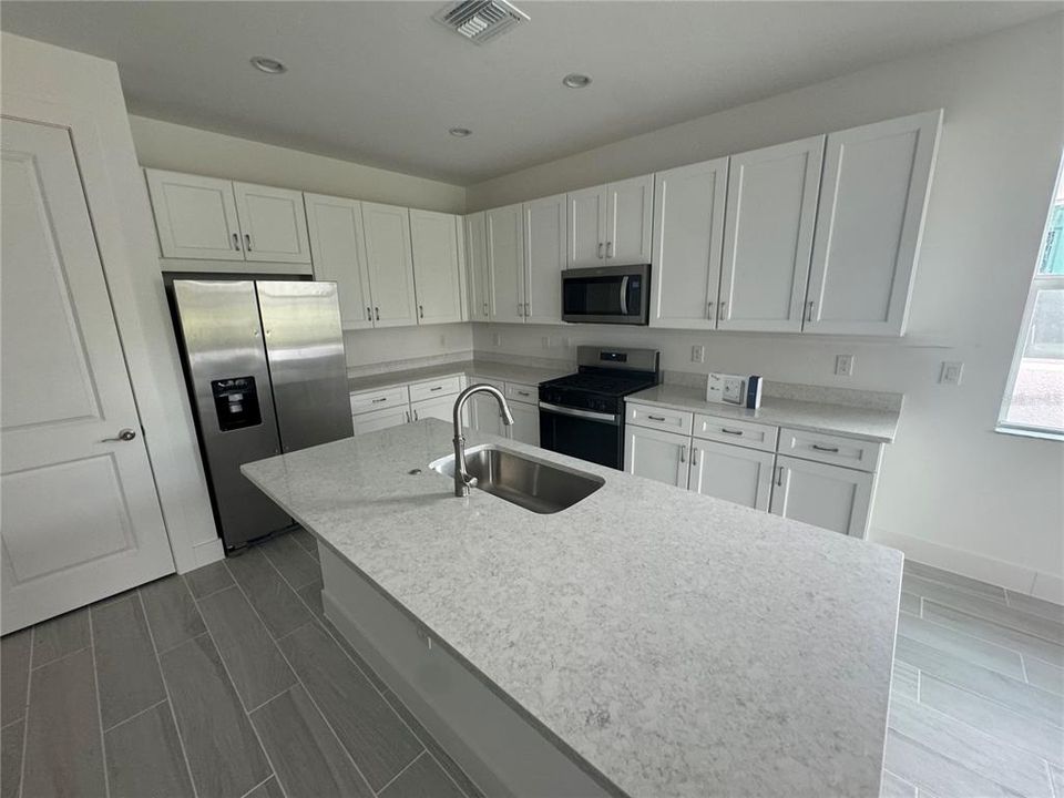 Kitchen layout with stainless steel Whirlpool appliances