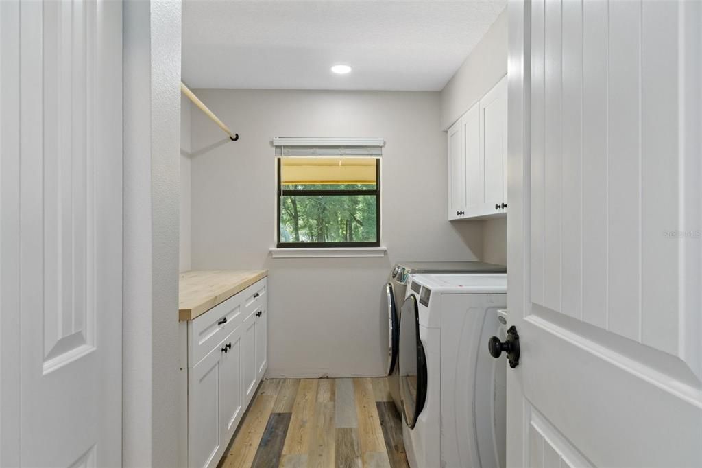 Good size laundry room with plenty of storage and a laundry tub.