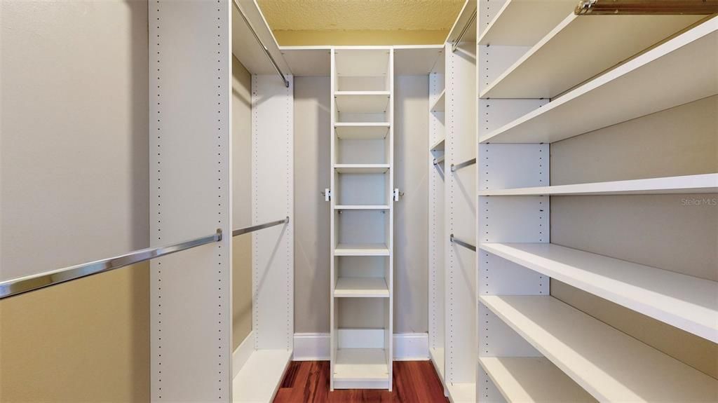 Primary bedroom walk in closet