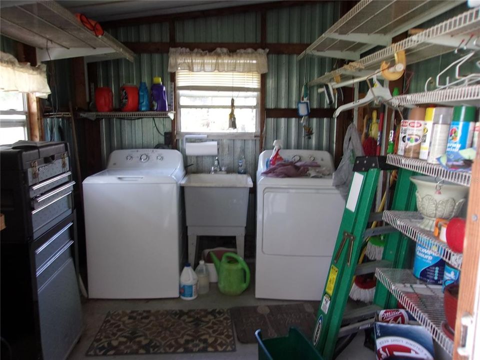 laundry in shed behind carport