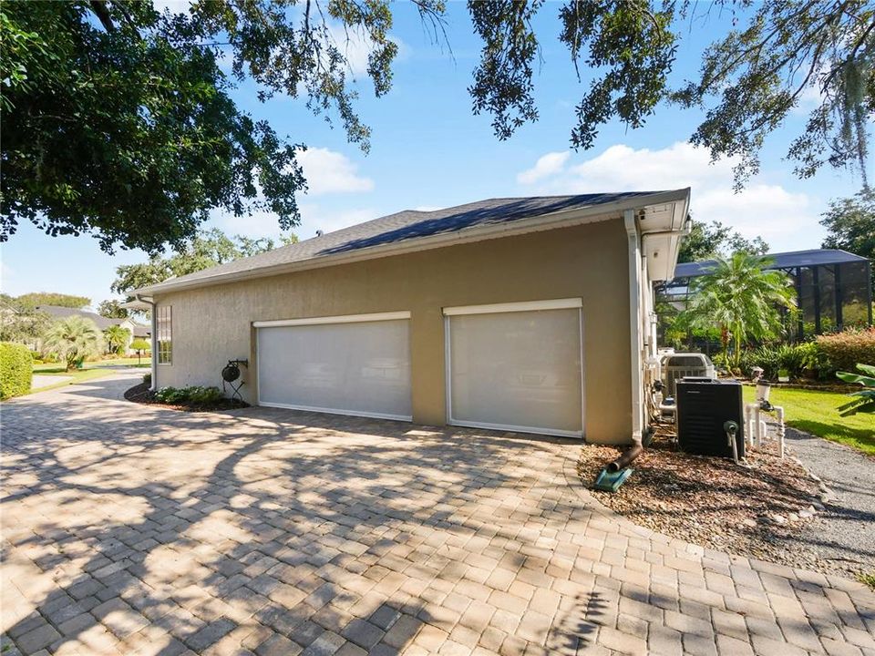 BACKSIDE OF HOME WITH SHADED AREA FOR A CARWASH STATION