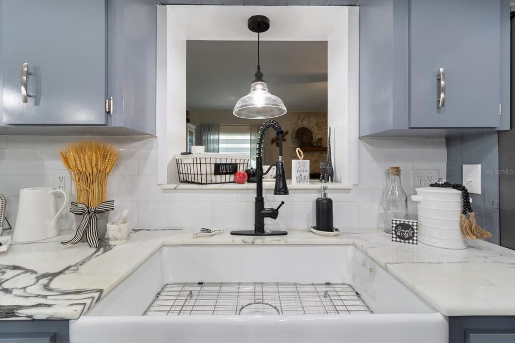 Marble Style Quartz Countertop, Farmhouse Sink & Pass-Through Window to the Family Room