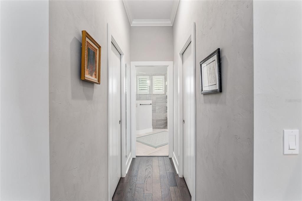 TWO LARGE WALK-IN CLOSETS WITH CUSTOM SHELVING IN OWNER'S SUITE