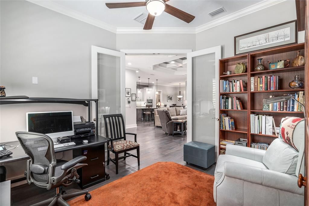 STUDY HAS GLASS FRENCH DOORS LOOKING INTO GREAT ROOM