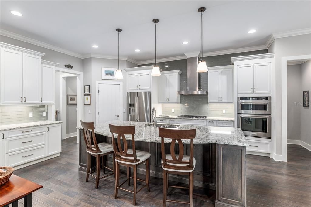 A COOK'S KITCHEN COMPLETE WITH ISLAND AND COFFEE BAR AREA