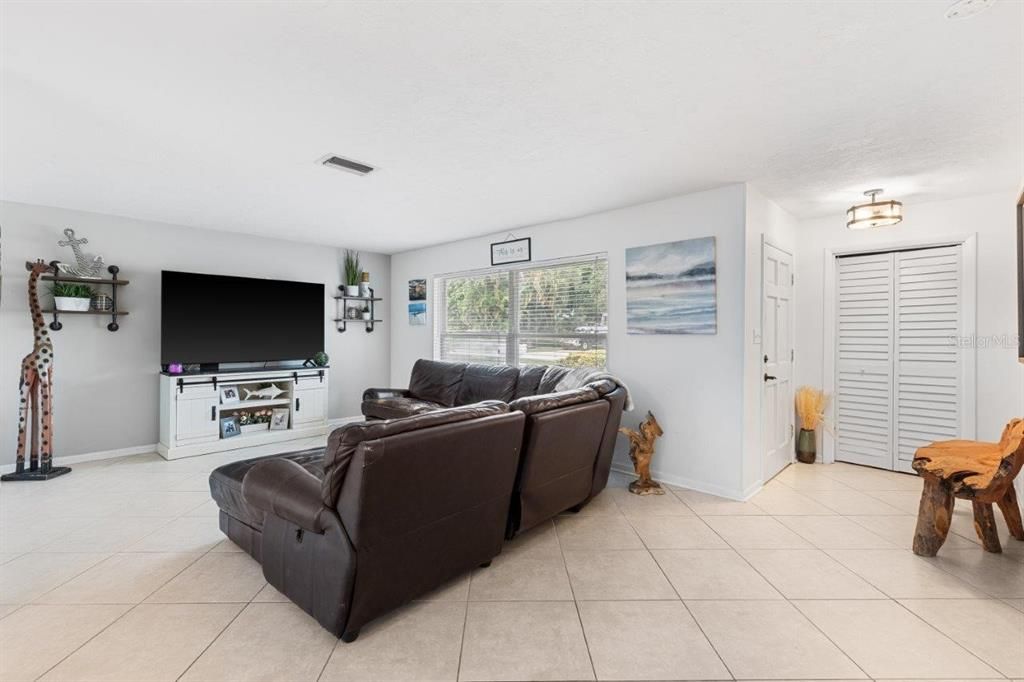 Living room featuring large windows letting in lots of natural light.