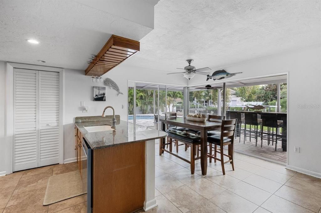 Dinette and the Kitchen surrounded by sliding glass doors with views of the back yard and canal.