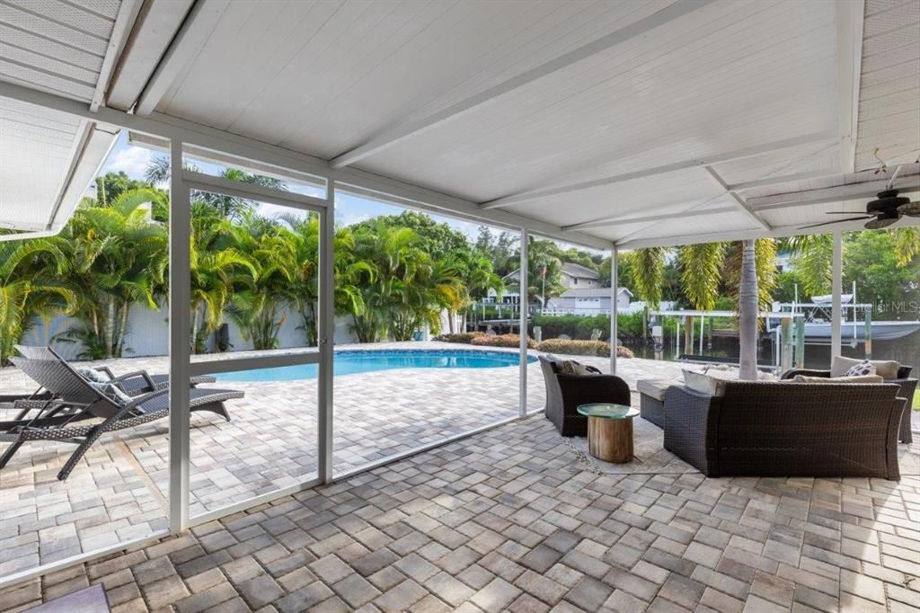 Screened-in Covered Lanai with beautiful views of the pool and canal.