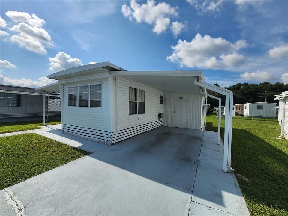 Expanded driveway & carport.