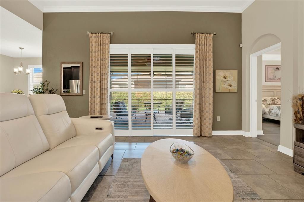 Oversized glass sliding doors provides seamless access to the screened-in lanai