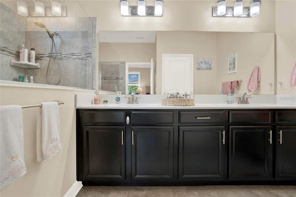 Master Bath offers a comfort-height vanity w/ dual sinks, quartz countertops and a water closet