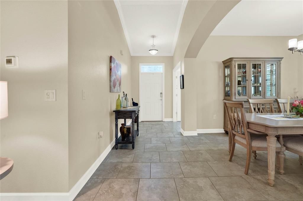 Foyer features a Transom Window and Crown Molding