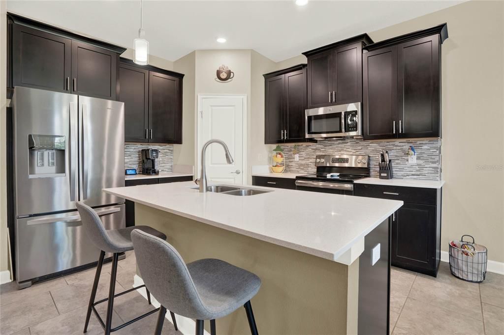 Timeless Espresso-stained Cabinetry with Crown Molding and Brushed Nickle Hardware