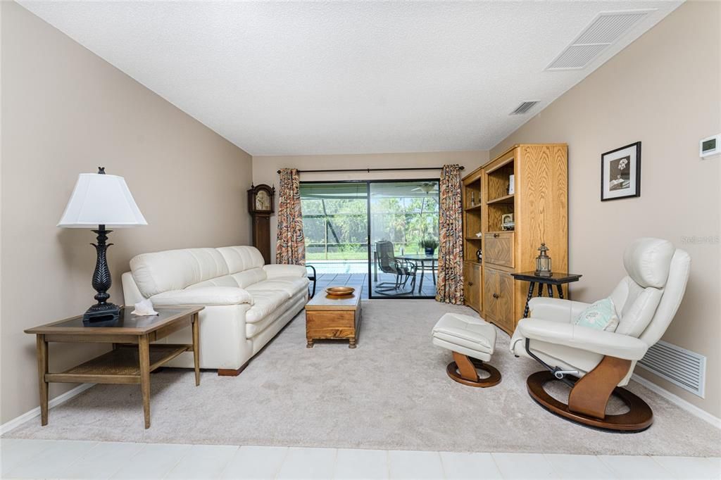 Living room has sliding glass doors to the lanai/pool area!