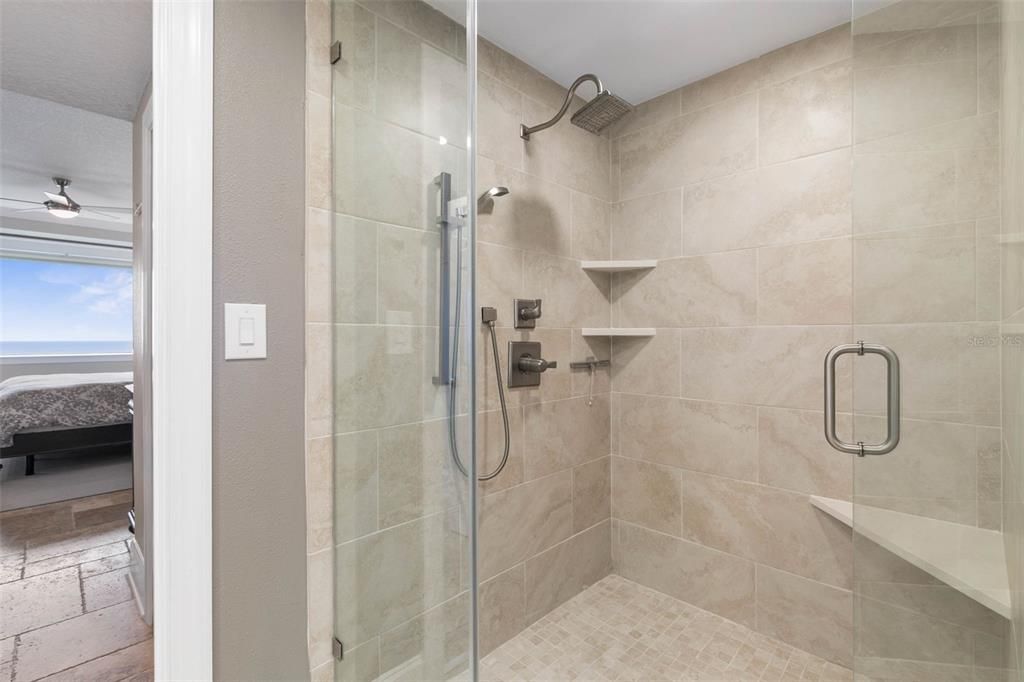 Enlarged walk-in shower w builtin seat and shelving!