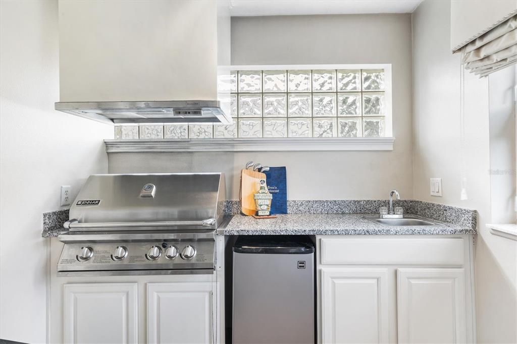 Summer kitchen with built-in Jenn-Air natural gas fed grill.