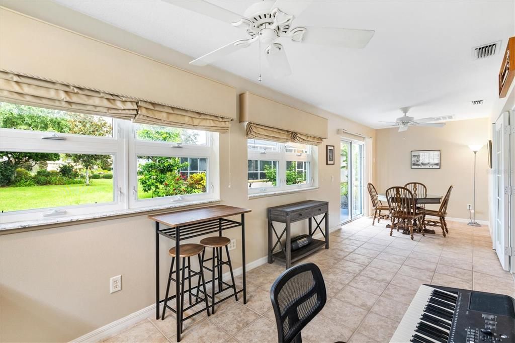 Florida room with windows to yard and custom privacy curtains