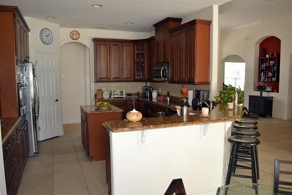 Kitchen with granite, counter top, high 42' cabinets and stainless appliances.