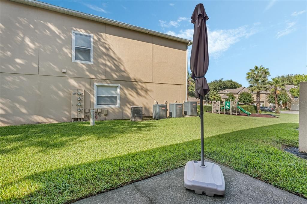 Rear patio with view to playground and pool