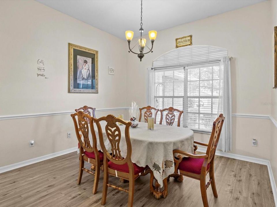 Formal dining room faces front porch.  plenty of space for hosting dinners.