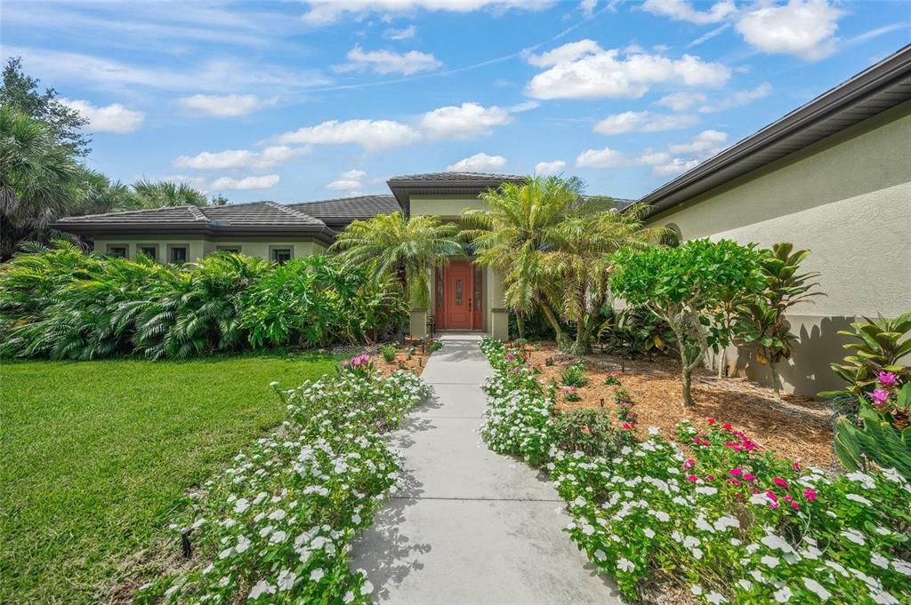 Front entrance with tropical landscaping.