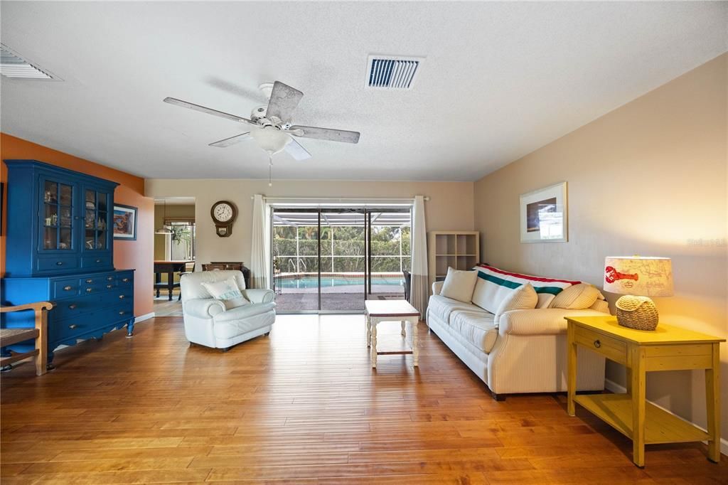 Engineered hardwood flooring and view of pool area