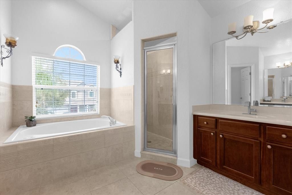 Primary bathroom with dual sink, garden soaking tub and walk in shower