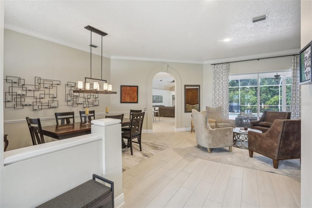 Living room, dinning room combo with sliding glass doors to screened lanai.  Custom window treatments.