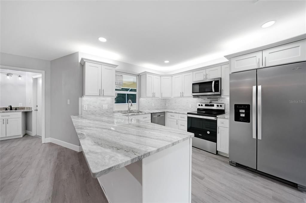 Kitchen Area with Pool Bath in the Background