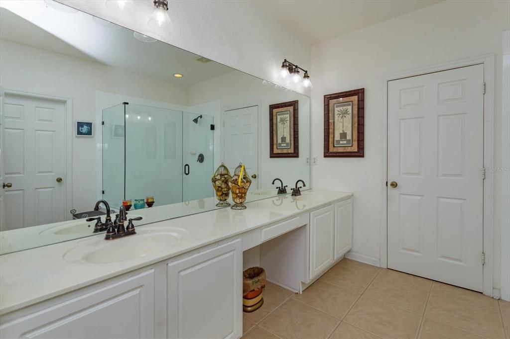 Primary bathroom with dual cultured marble sinks and knee space