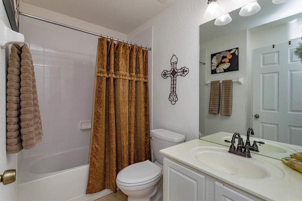 Tile floors and cultured marble vanity in guest bathroom