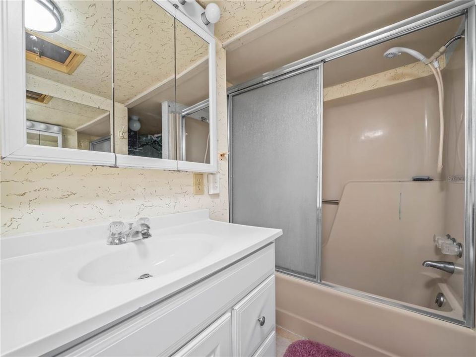 Bath and shower and additional storage in back