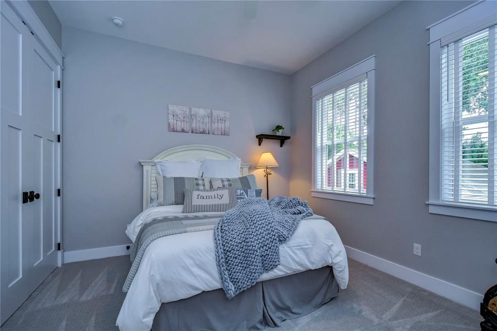 Primary bedroom has double doors to back porch