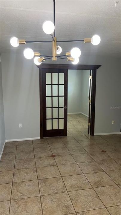 Living room with double doors to 2nd bedroom