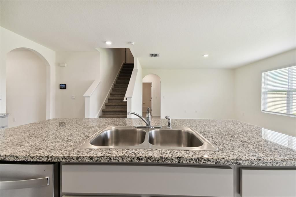 Double stainless sink at breakfast bar.