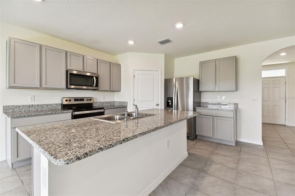 Kitchen granite countertop island with a breakfast bar.