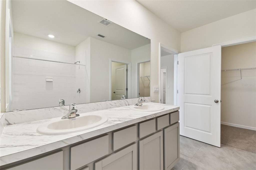 Primary bathroom with double sink vanity.