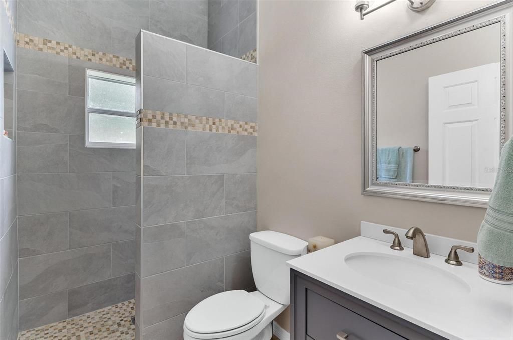 Guest Bathroom with Custom Walk-in Shower with Tumbled Travertine Flooring