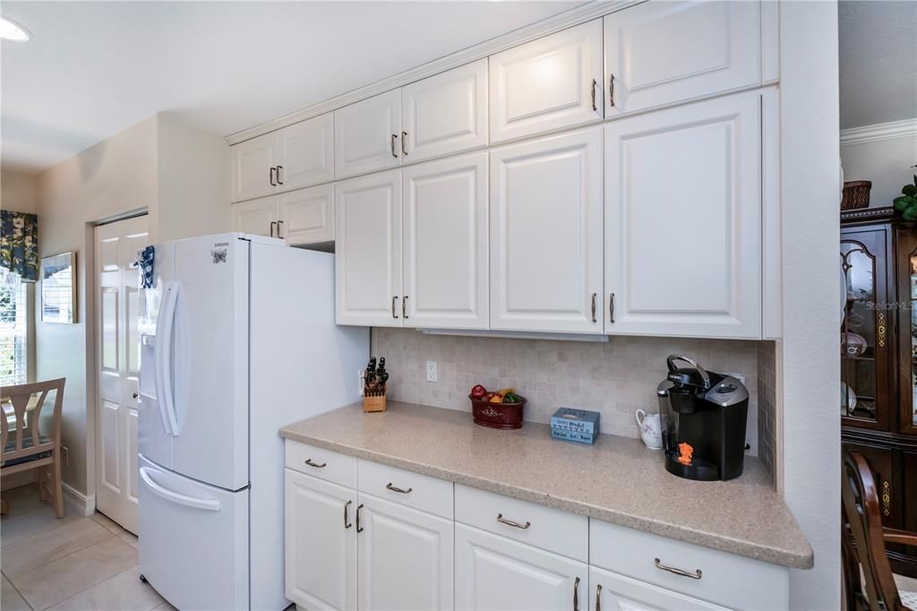 Custom-designed additional cabinetry, solid surface counters and stone backsplash! Wow!