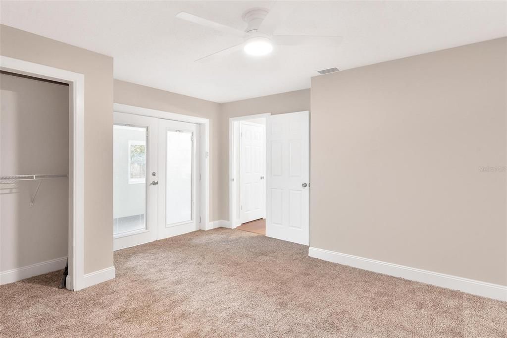 Primary Bedroom with French Doors leading to Sunroom