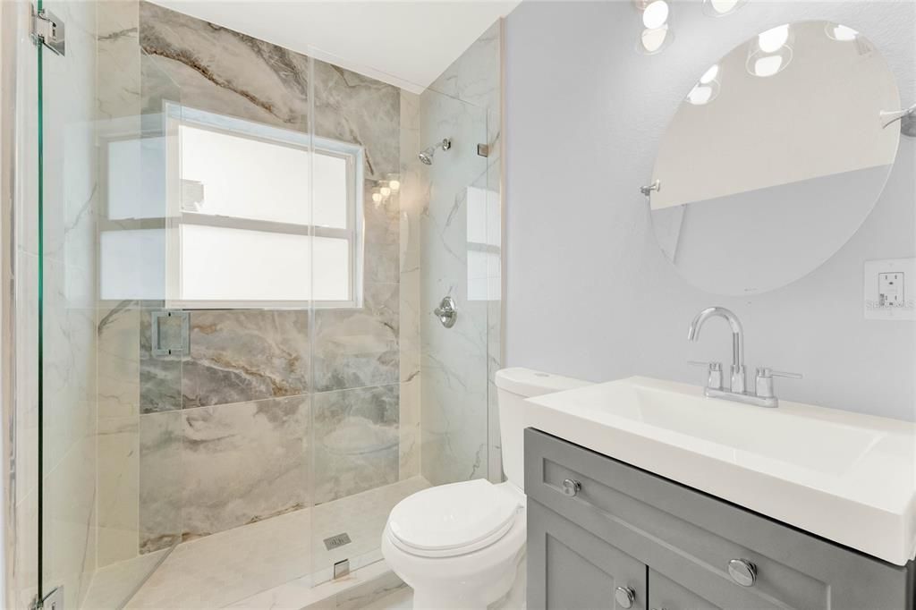 The second full bath is also fully updated with built-in storage and another must see shower also enclosed in seamless glass.