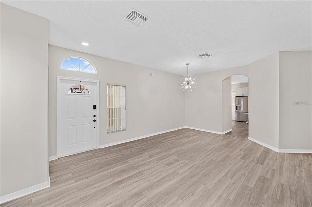 Living/Dining rooms, luxury vinyl floors, entrance to kitchen