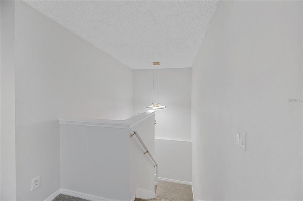 Stairs to second story opening to a loft