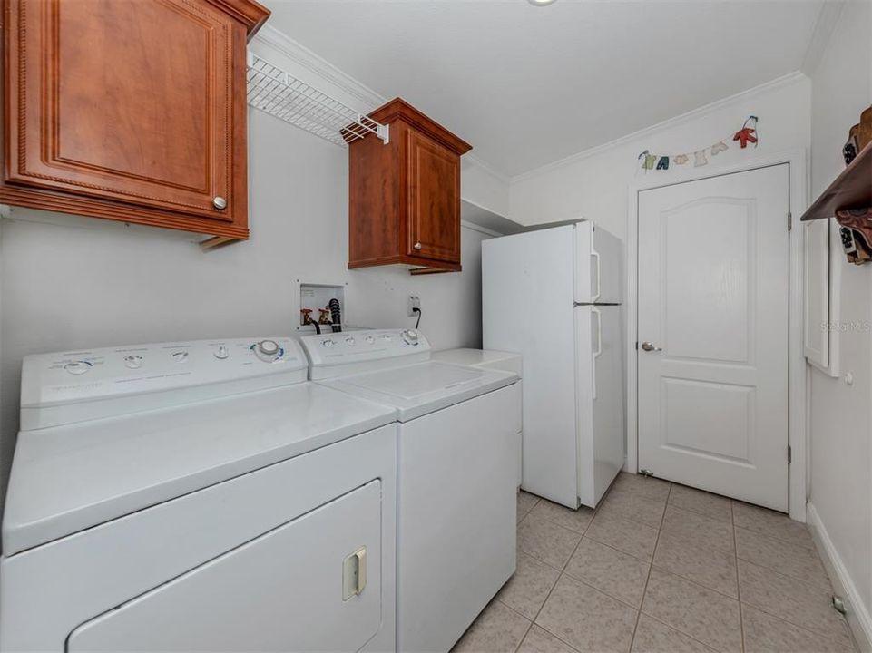 Laundry room with 2nd refrigerator.